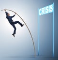 Businessman pole vaulting over crisis in business concept Royalty Free Stock Photo