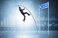 The businessman pole vaulting over crisis in business concept Royalty Free Stock Photo