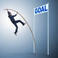 Businessman pole vaulting towards his goal in business concept Royalty Free Stock Photo