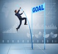 Businessman pole vaulting towards his goal in business concept Royalty Free Stock Photo