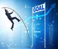Businessman pole vaulting towards his goal in business concept Royalty Free Stock Photo