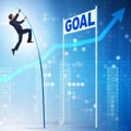 Businessman pole vaulting towards his goal in business concept Royalty Free Stock Photo