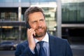 Businessman portrait. Man on smart phone. Casual urban professional business man using smartphone smiling happy Royalty Free Stock Photo