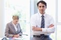 Businessman posing while his colleague is working Royalty Free Stock Photo