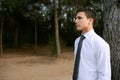 Businessman posing relaxed on a park forest