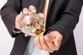 Businessman pouring coins fromn the glass to his hand, concept of saving  money for finance accounting, growing business Royalty Free Stock Photo