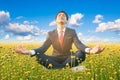 Businessman practice meditation in flower field Royalty Free Stock Photo