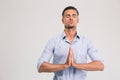 Businessman praying with closed eyes