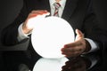 Businessman Predicting Future With Crystal Ball