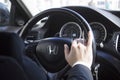 Businessman in a presentable luxury car, Honda. On the steering wheel of a Honda man`s hand in a suit