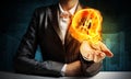 Businessman presenting flaming lightbulb.