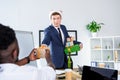 Businessman presenting gift to colleague Royalty Free Stock Photo