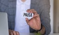 Businessman presenting Pause word on white card