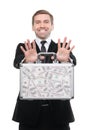 Businessman presenting a suitcase full of one hundred US dollars