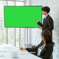 Businessman presenting work and flowchart on blank television monitor mock up screen in a conference room