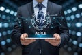 Businessman holding tablet displaying agile software development concept with code and network connections Royalty Free Stock Photo