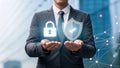 Businessman presents cybersecurity shield and padlock for data protection and privacy Royalty Free Stock Photo