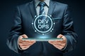 Businessman presents devops concept on a digital tablet for modern software development and it operations Royalty Free Stock Photo