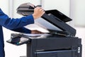 Businessman press button on panel of printer photocopier network , Working on photocopies in the office concept , printer is