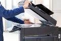 Businessman press button on panel of printer photocopier network , Working on photocopies in the office concept , printer is