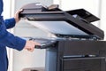 Businessman press button on panel of printer photocopier network , Working on photocopies in the office concept , printer is