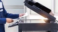 Businessman press button on panel of printer photocopier network , Working on photocopies in the office concept , printer is