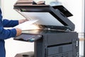 Businessman press button on panel of printer photocopier network , Working on photocopies in the office concept , printer is