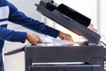 Businessman press button on panel of printer photocopier network , Working on photocopies in the office concept , printer is