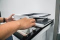 Businessman press on office printer for copying and scanning documents Royalty Free Stock Photo