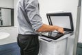 Businessman press paper sheet on printer for copying and scanning documents Royalty Free Stock Photo