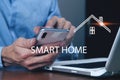 Businessman presses smart home icon Royalty Free Stock Photo