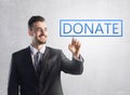 Businessman pressing a donate sign