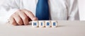 Businessman pressing his finger on the wooden cubes with the word hire. Job employment, business hiring