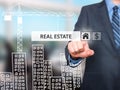 Businessman pressing real estate button on virtual screens Royalty Free Stock Photo