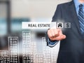 Businessman pressing real estate button on virtual screens Royalty Free Stock Photo