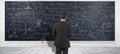 Businessman front of problems on chalkboard, conceptual banner