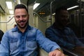 Businessman professional wearing denim shirt enjoying travel while riding home by subway train. Concept of commute, transport