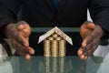 Businessman Protecting House Made Of Money Royalty Free Stock Photo