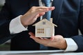 Businessman protecting house model with hands. Real estate and property Insurance concept Royalty Free Stock Photo