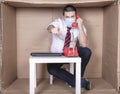 Businessman with a protective mask on his mouth conducts a conversation on the phone, points his finger at you Royalty Free Stock Photo