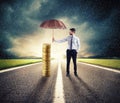 Businessman protects his money savings with umbrella. concept of insurance and money protection Royalty Free Stock Photo