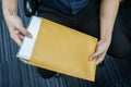 Businessman pull confidential documents from brown envelope in office