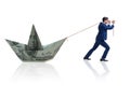 The businessman pulling boat made from dollar banknote Royalty Free Stock Photo