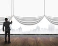 businessman pulling open blank white curtain covered gray cityscape background Royalty Free Stock Photo