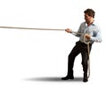 Businessman pulling rope