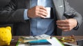 Businessman pulls his leather wallet into suit pocket