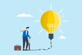 Businessman pumping idea lightbulb balloon