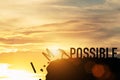 Businessman push impossible wording to possible wording on top of mountain with sunlight. Positive mindset concept Royalty Free Stock Photo