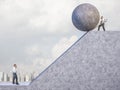 Businessman pushes big concrete sphere towards the slope where there is another man