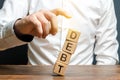 A businessman pushes down a tower of cubes with the word Debt. concept of financial relief, loan restructuring. Financial